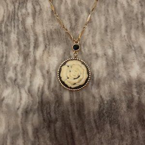 Gold tone necklace with black/cream rose cameo